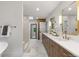Contemporary bathroom featuring double vanity, and modern fixtures, with a shower in the background at 4 Doral Ln, Littleton, CO 80123
