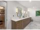 Elegant bathroom features a double vanity, quartz countertop and stylish mirrors at 4 Doral Ln, Littleton, CO 80123