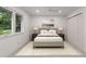Bright and airy bedroom with a large window, plush rug and neutral decor at 4 Doral Ln, Littleton, CO 80123
