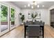 Bright dining room with a modern chandelier, gray accent chairs and view to outdoor patio at 4 Doral Ln, Littleton, CO 80123