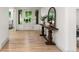 Warm and inviting entryway with hardwood floors, a decorative mirror, and a view of the front door at 4 Doral Ln, Littleton, CO 80123