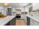Spacious kitchen with island and breakfast bar, stainless appliances, and stylish countertops at 4 Doral Ln, Littleton, CO 80123