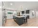 Eat-in kitchen with updated stainless appliances, large island, and modern lighting fixtures at 4 Doral Ln, Littleton, CO 80123