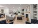 Bright living room with modern fireplace, light wood floors, and open concept to the kitchen at 4 Doral Ln, Littleton, CO 80123