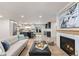 Stylish living room with open layout, kitchen view, fireplace, and modern decor, ideal for entertaining guests at 4 Doral Ln, Littleton, CO 80123