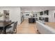 Open floor plan with a kitchen island, stainless appliances and a sun-filled living room at 4 Doral Ln, Littleton, CO 80123