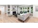Cozy living room with fireplace, built-in bookshelves, and large windows offering natural light and backyard views at 4 Doral Ln, Littleton, CO 80123