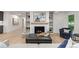 Inviting living room featuring a fireplace, built-in shelving, and views of the outdoor space through large windows at 4 Doral Ln, Littleton, CO 80123
