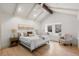 Serene main bedroom with vaulted ceiling, large windows, and a cozy seating area, creating a relaxing retreat at 4 Doral Ln, Littleton, CO 80123
