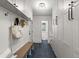 Mudroom featuring white storage cabinets, drawers, bench, and black hardware at 4 Doral Ln, Littleton, CO 80123