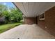 View of the covered patio showcasing brick exterior and entrance to the backyard at 4 Doral Ln, Littleton, CO 80123