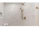Modern shower stall with brushed gold fixtures, white tile walls, and a built-in niche at 4 Doral Ln, Littleton, CO 80123