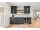 Entertainer's wet bar with gray cabinets, shelving, and wine cooler at 4 Doral Ln, Littleton, CO 80123