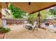 Covered back patio with gravel, outdoor seating, and foliage at 18206 E Loyola Dr, Aurora, CO 80013