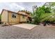 Backyard view of the home featuring gravel ground cover, a concrete patio, and lush greenery at 18206 E Loyola Dr, Aurora, CO 80013