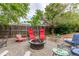 Backyard with a gravel area, outdoor seating surrounding a fire pit, and a wooden fence at 18206 E Loyola Dr, Aurora, CO 80013