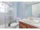 Bathroom featuring a glass shower, white toilet, vanity, and basin at 18206 E Loyola Dr, Aurora, CO 80013