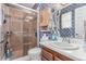 Bathroom features a shower and vanity with wood cabinets and sink at 18206 E Loyola Dr, Aurora, CO 80013