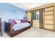 Bedroom with blue and yellow walls, carpet, and a daybed at 18206 E Loyola Dr, Aurora, CO 80013
