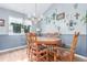 Dining area featuring a chandelier, six-chair table, and multiple decorative wall crosses at 18206 E Loyola Dr, Aurora, CO 80013