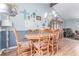 Dining area with a wooden table, six chairs, and a view of the adjacent living room at 18206 E Loyola Dr, Aurora, CO 80013