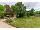 Inviting two-story home with a green lawn and mature trees adding curb appeal at 18206 E Loyola Dr, Aurora, CO 80013