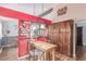 Eat-in kitchen features wood cabinets, a wood table, and colorful wall decor at 18206 E Loyola Dr, Aurora, CO 80013