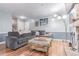 Comfortable living room featuring a gray sectional, unique lighting, and wood-look flooring at 18206 E Loyola Dr, Aurora, CO 80013