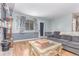 Living room with a gray sectional, window, and a view to the backyard at 18206 E Loyola Dr, Aurora, CO 80013