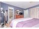 Bright main bedroom with ensuite bathroom features blue wallpaper and wood floors at 18206 E Loyola Dr, Aurora, CO 80013