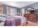 Spacious main bedroom features blue wallpaper, wood floors, and a wood dresser at 18206 E Loyola Dr, Aurora, CO 80013