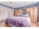 Spacious main bedroom features blue wallpaper, wood floors, and a large built-in closet at 18206 E Loyola Dr, Aurora, CO 80013
