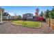 Landscaped backyard with a grassy area and gravel pathway at 678 Kryptonite Dr, Castle Rock, CO 80108