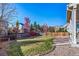 Landscaped backyard with a grassy area and gravel border at 678 Kryptonite Dr, Castle Rock, CO 80108