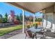 Covered patio with seating area overlooking a fenced backyard at 678 Kryptonite Dr, Castle Rock, CO 80108