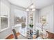 Bright breakfast nook with glass table, striped chairs, and access to backyard at 678 Kryptonite Dr, Castle Rock, CO 80108