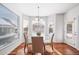 Breakfast nook with glass table, striped chairs, and bright windows at 678 Kryptonite Dr, Castle Rock, CO 80108