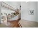 Two-story entryway with curved staircase and hardwood floors at 678 Kryptonite Dr, Castle Rock, CO 80108