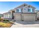 Two-story house with two-car garage, landscaping and a welcoming front porch at 678 Kryptonite Dr, Castle Rock, CO 80108