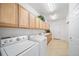 Bright laundry room with washer, dryer, cabinets, and sink at 678 Kryptonite Dr, Castle Rock, CO 80108