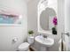 Clean powder room with pedestal sink, toilet, and decorative mirror at 678 Kryptonite Dr, Castle Rock, CO 80108