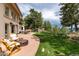Spacious backyard with a fire pit, lounge chairs, and landscaped yard, perfect for outdoor entertaining at 1425 Autumnwood Ln, Evergreen, CO 80439