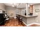 Basement bar featuring countertop, dark wood cabinets, piano, and bar stool seating at 1425 Autumnwood Ln, Evergreen, CO 80439