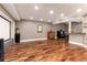 Spacious basement featuring wooden floors, a projector screen, and a bar counter at 1425 Autumnwood Ln, Evergreen, CO 80439