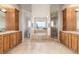 Elegant bathroom with a soaking tub, dual vanities, marble tile, and a glass-enclosed shower at 1425 Autumnwood Ln, Evergreen, CO 80439