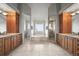 Luxurious bathroom with double sinks, travertine floors, soaking tub, and glass shower at 1425 Autumnwood Ln, Evergreen, CO 80439
