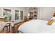Bright bedroom with hardwood floors, french doors, and an archway leading to the living room at 1425 Autumnwood Ln, Evergreen, CO 80439