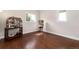 Bonus room featuring hardwood floors, natural light, and charming miniature doll houses at 1425 Autumnwood Ln, Evergreen, CO 80439