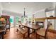 Spacious dining room with fireplace, wood floors, and large windows with backyard views at 1425 Autumnwood Ln, Evergreen, CO 80439