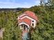 Stunning home with red tile roof nestled in the trees, offering scenic views at 1425 Autumnwood Ln, Evergreen, CO 80439